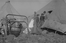 Possibly: Setting up a tent in the camp for white flood refugees, Forrest City, Arkansas, 1937. Creator: Walker Evans