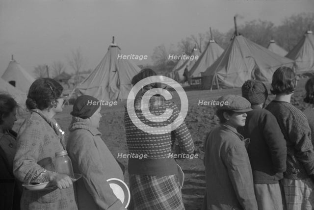 Possibly: Refugees lined up at meal time in the camp for white flood...Forest City, Arkansas, 1937. Creator: Walker Evans.