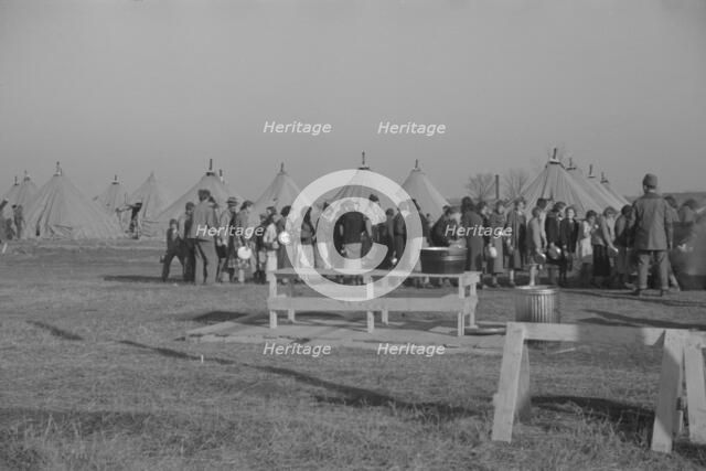 Possibly: Refugees lined up at meal time in the camp for white flood...Forest City, Arkansas, 1937. Creator: Walker Evans.