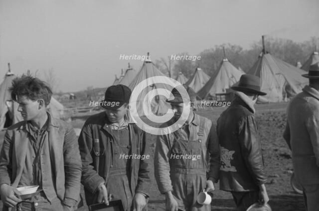 Possibly: Refugees lined up at meal time in the camp for white flood...Forest City, Arkansas, 1937. Creator: Walker Evans.