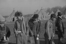 Possibly: Refugees lined up at meal time in the camp for white flood...Forest City, Arkansas, 1937. Creator: Walker Evans