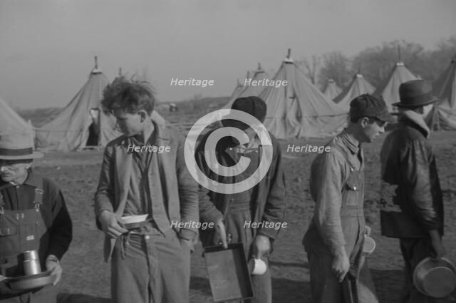 Possibly: Refugees lined up at meal time in the camp for white flood...Forest City, Arkansas, 1937. Creator: Walker Evans.