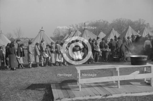 Possibly: Refugees lined up at meal time in the camp for white flood...Forest City, Arkansas, 1937. Creator: Walker Evans.