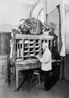 Postman sorting mail at the post office, Landskrona, Sweden, 1940. Creator: Unknown