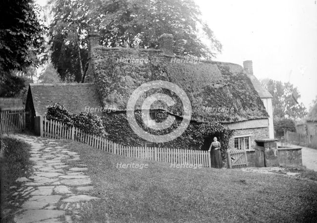 Postmistress in front of the post office at Upper Boddington, Northamptonshire, c1873-c1923. Artist: Alfred Newton & Sons