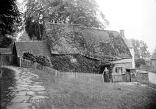 Postmistress in front of the post office at Upper Boddington, Northamptonshire, c1873-c1923. Artist: Alfred Newton & Sons