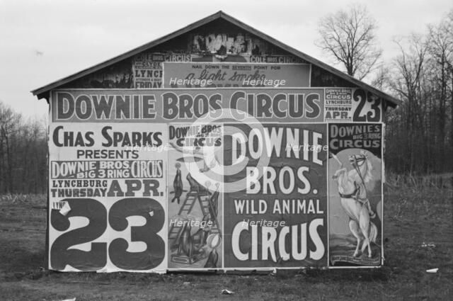 Posters covering a building near Lynchburg to advertise a Downie Bros. circus, 1936. Creator: Walker Evans.