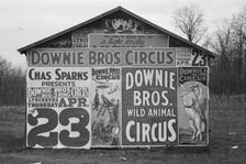 Posters covering a building near Lynchburg to advertise a Downie Bros. circus, 1936. Creator: Walker Evans