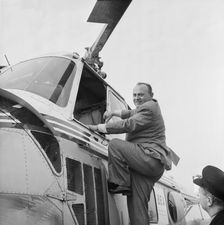 P.A. Gaglardi, Minister of Highways for British Columbia, climbing into a helicopter, M1, 22/5/1959. Creator: John Laing plc