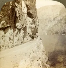 Path blasted out of the towering cliffs for a road around Oifjords Lake, Norway 1905. Creator: Unknown