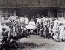 Paying wages to tea estate labourers, Bengal, 1880s. Creator: Bourne & Shepherd