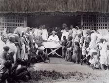 Paying wages to tea estate labourers, Bengal, 1880s. Creator: Bourne & Shepherd