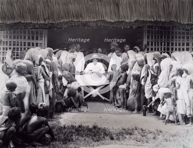 Paying wages to tea estate labourers, Bengal, 1880s. Creator: Bourne & Shepherd.