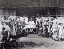 Paying wages to tea estate labourers, Bengal, 1880s. Creator: Bourne & Shepherd