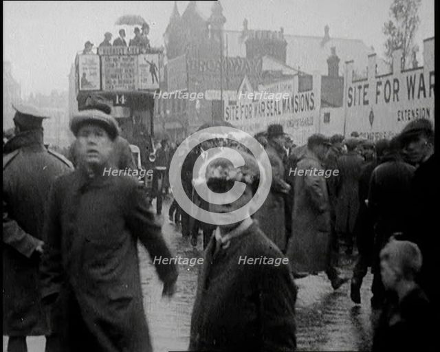 Packed Pavement on a British Street. Behind the Pedestrians Is a Sign Reading 'Site for..., 1921. Creator: British Pathe Ltd.