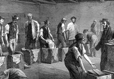 Packing tea in the warehouses of the East & West India Dock Company, London, 1874 Creator: Unknown