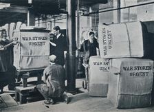 Packing the bales of khaki for despatch to the Government, c1914