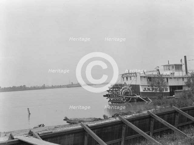 Paddle wheel steamboat on river, New Orleans, between 1920 and 1926. Creator: Arnold Genthe.