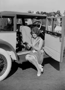 Paddy Naismith pouring a drink from the cocktail bar in her Ballot at the Southport Rally, 1928. Artist: Bill Brunell