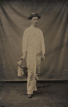 Painter in Paint-spattered Overalls with Brushes and Paint Can, 1870s-80s. Creator: Unknown