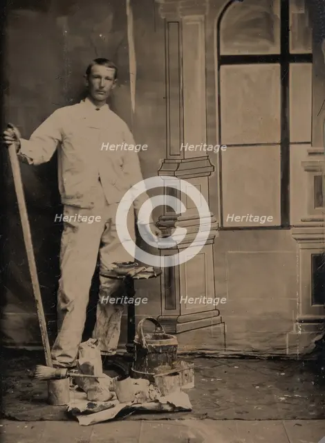 [Painter, Standing in Front of a Painted Window Backdrop, with Brushes, Bucket, and P..., 1870s-80s. Creator: Unknown.