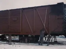 Painting a car at the repair or "rip" tracks at North Proviso(?), C & NW RR, Chicago, Ill., 1942. Creator: Jack Delano