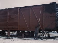 Painting a car at the repair or "rip" tracks at North Proviso(?), C & NW RR, Chicago, Ill., 1942. Creator: Jack Delano