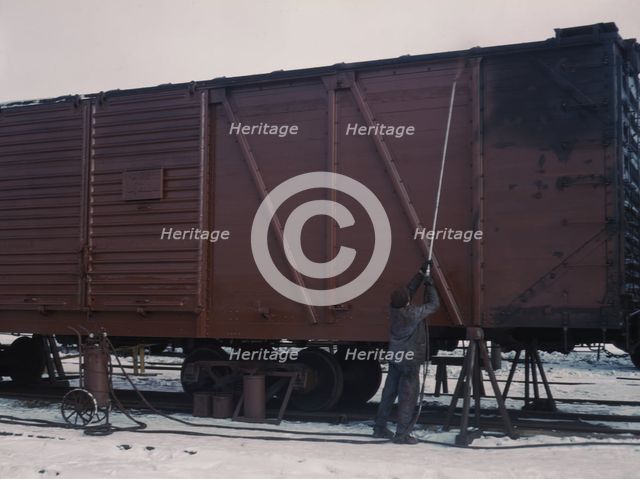 Painting a car at the repair or "rip" tracks at North Proviso(?), C & NW RR, Chicago, Ill., 1942. Creator: Jack Delano.
