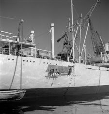 Painting the hull of a ship in the harbour of Gothenburg, Sweden, 1960. Creator: Torkel Lindeberg