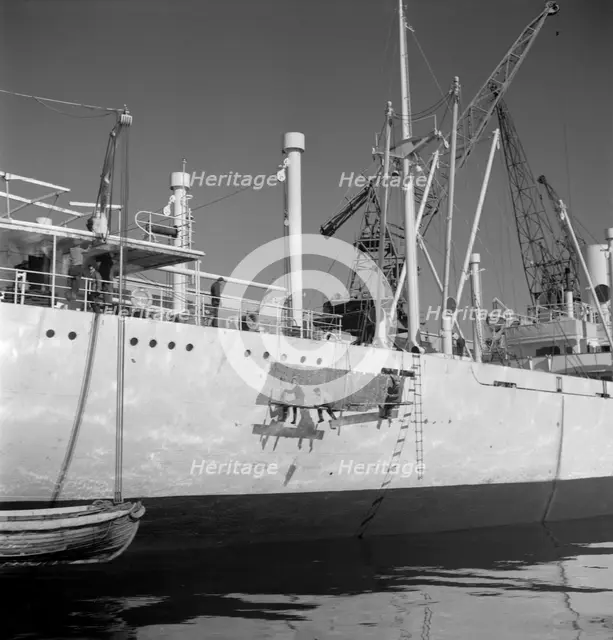 Painting the hull of a ship in the harbour of Gothenburg, Sweden, 1960. Creator: Torkel Lindeberg.