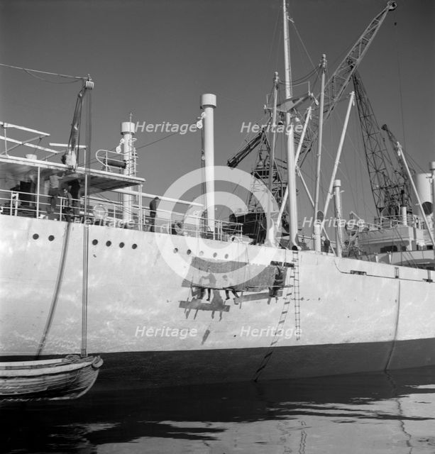 Painting the hull of a ship in the harbour of Gothenburg, Sweden, 1960. Creator: Torkel Lindeberg.