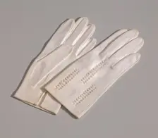 Pair of light cream gloves with openwork design from Mae's Millinery Shop, 1941-1994. Creator: Van Raalte
