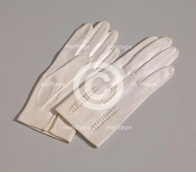 Pair of light cream gloves with openwork design from Mae's Millinery Shop, 1941-1994. Creator: Van Raalte.