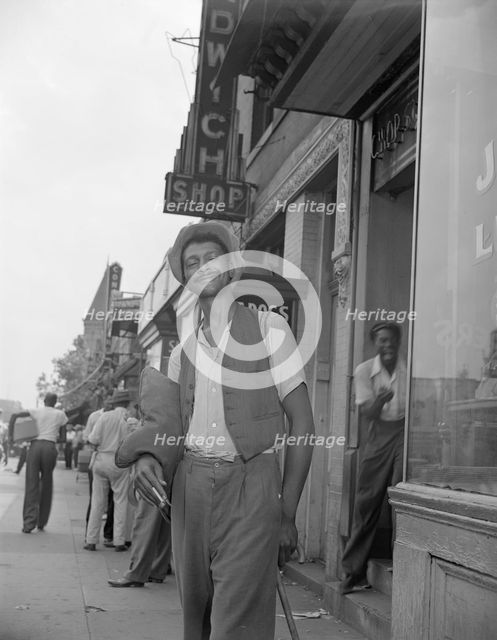 Panhandler on 7th Street, N.W., Washington, D.C., 1942. Creator: Gordon Parks.