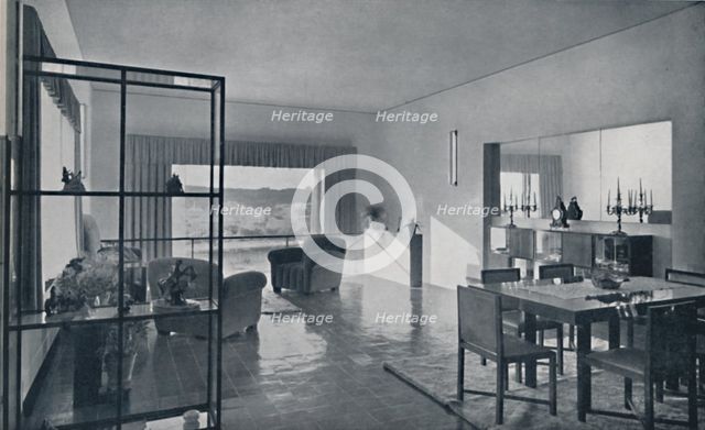 'Paniconi and Pediconi. A dining room with a large window and curtains designed to frame a beautiful Artist: Unknown.
