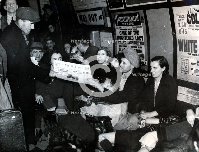 Paper seller down in the underground, London, c.1940. Creator: Unknown.