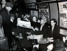 Paper seller down in the underground, London, c.1940. Creator: Unknown