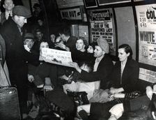 Paper seller down in the underground, London, c.1940