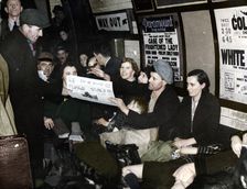 Paper seller down in the underground, London, c.1940