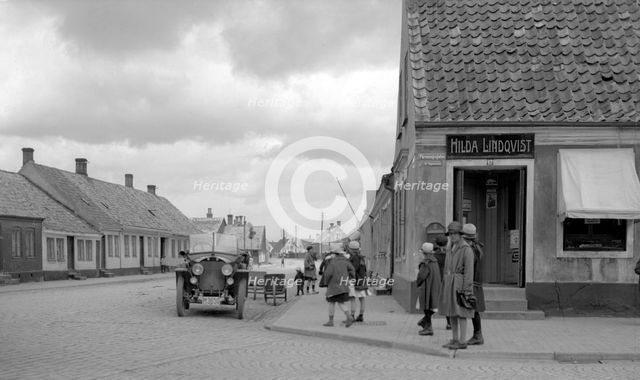 Parked car and children on a street corner, Landskrona, Sweden, 1925. Creator: Unknown.