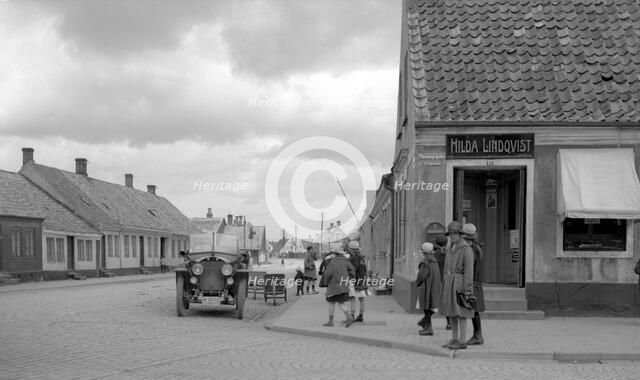Parked car and children on a street corner, Landskrona, Sweden, 1925. Artist: Unknown