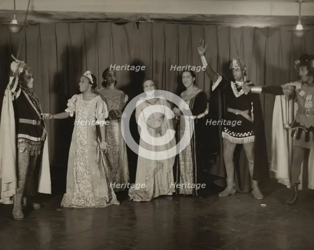Parker Watkins with raised sword, and others, 1936. Creator: Eagle Ezzes & Mipaas.