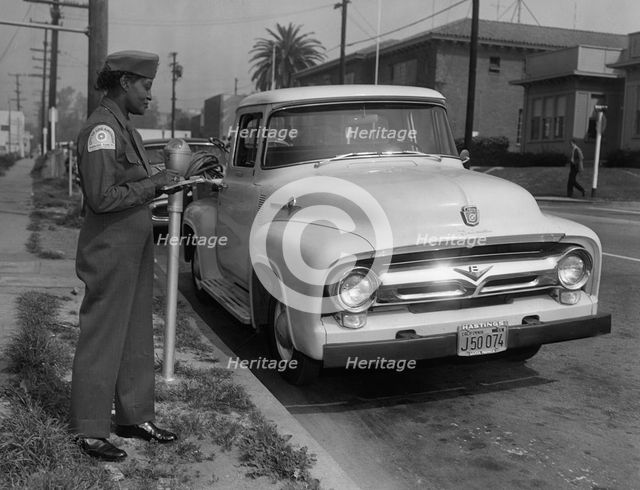 Parking meter with Los Angeles parking control officer 1958. Creator: Unknown.