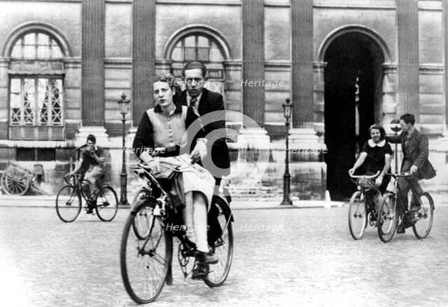 Parisians travelling by bicycle, German-occupied Paris, July 1940. Artist: Unknown
