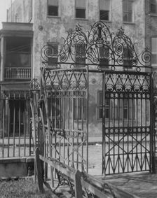 Park gate and houses, [36 Chalmers Street through Washington Park Gate], Charleston..., c1920-c1926. Creator: Arnold Genthe
