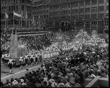 Participants Walking Alongside Floats in a Large Parade During the World Congress for..., 1938. Creator: British Pathe Ltd