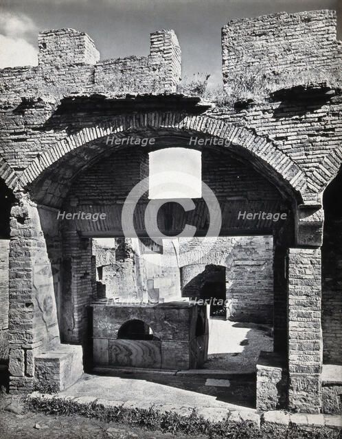 Partly ruined buildings in Ostia identified as a tavern or hot-food shop (thermopolium)..., 1920-9. Creator: Domenico Anderson.
