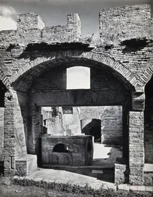Partly ruined buildings in Ostia identified as a tavern or hot-food shop (thermopolium)..., 1920-9. Creator: Domenico Anderson