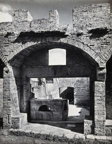 Partly ruined buildings in Ostia identified as a tavern or hot-food shop (thermopolium)..., 1920-9. Creator: Domenico Anderson