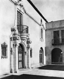 Pasadena, California, Mrs. Herbert Coppell home - detail of ornate doorway and balcony above, 1917. Creator: Frances Benjamin Johnston